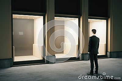 Businessman looking at shop exterior Stock Photo