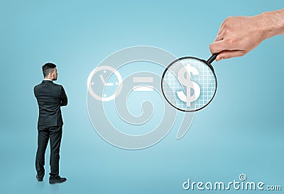 Businessman looking at sigh 'time is money' with big man's hand enlarging dollar sign by magnifier Stock Photo