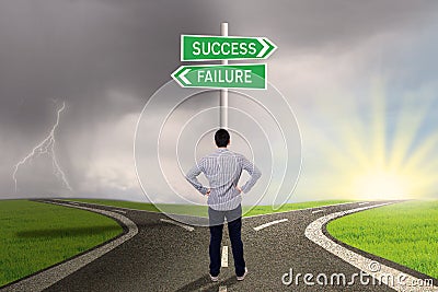 Businessman looking at sign of success or failure Stock Photo