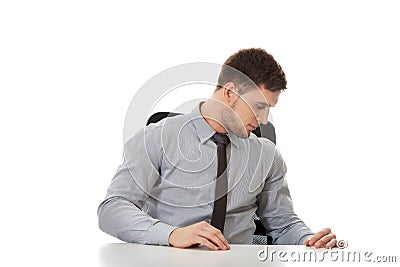 Businessman looking under the desk. Stock Photo