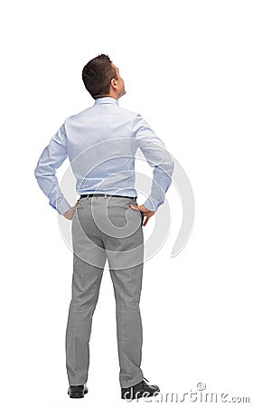 Businessman looking up from back Stock Photo