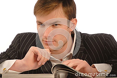 Businessman looks magazine Stock Photo