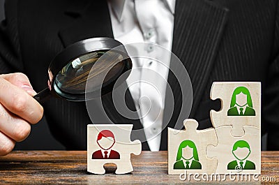 Businessman with a magnifying glass examines puzzle with an incompetent and toxic worker. The concept of the organization Stock Photo