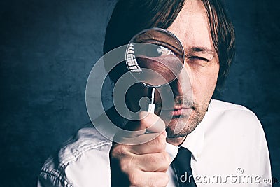 Businessman with magnifying glass, tax inspector doing financial Stock Photo