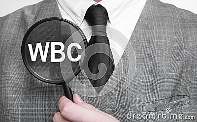 Businessman with magnifying glass on the white background. WBC sign Stock Photo