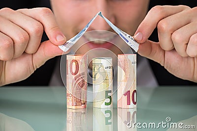Businessman Making House Of Banknotes Stock Photo