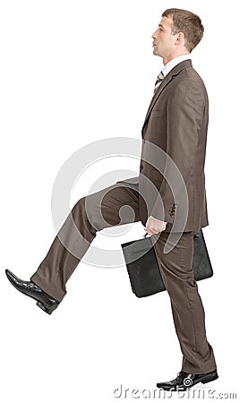 Businessman making large step with suitcase Stock Photo