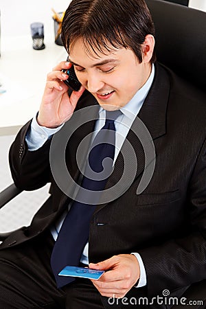 Businessman making purchase by phone and ca Stock Photo