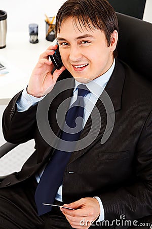 Businessman making purchase by phone and card Stock Photo