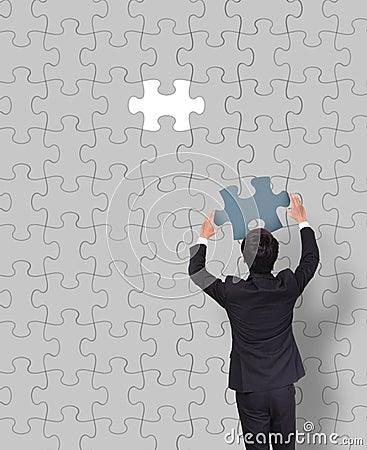 Businessman making a puzzle Stock Photo