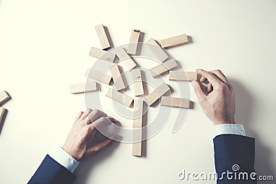 Businessman making a pyramid wooden cubes Stock Photo