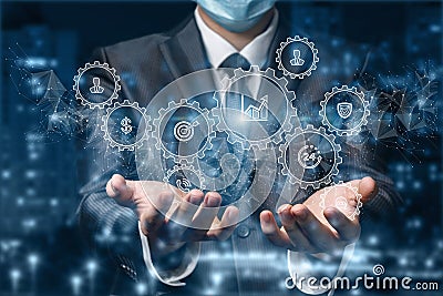 Businessman in the mask shows the mechanisms of business management Stock Photo