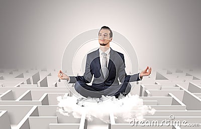 Businessman meditates on a cloud with maze concept Stock Photo