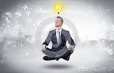 Businessman meditates with enlightenment concept Stock Photo