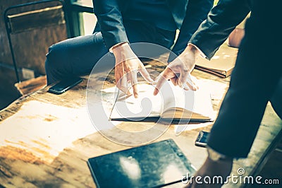 Businessman meeting about business plan and marketing in the future. they are looking and point finger to detail in notebook Stock Photo