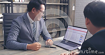 Businessman mentor coworker at office desk as team leader bossy manager. Two business people talking together start up new project Stock Photo