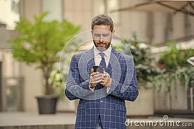 businessman messaging on phone in hands. businessman messaging on phone outdoor. businessman messaging on phone in the Stock Photo