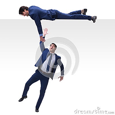 The businessman offering helping hand to falling colleague Stock Photo