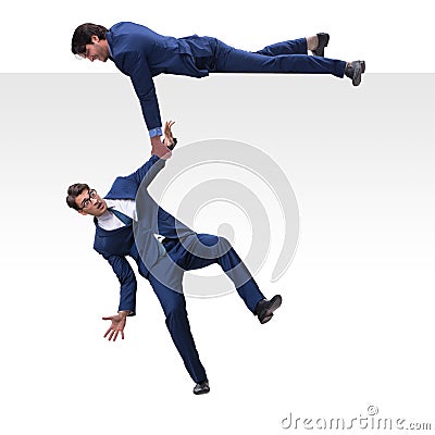 The businessman offering helping hand to falling colleague Stock Photo