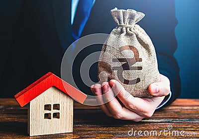 A businessman offers a loan to buy a house. Grants and financial assistance to rebuild and buy a home. Bank approval of a mortgage Stock Photo