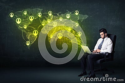 Businessman in office with laptop and social network world map Stock Photo