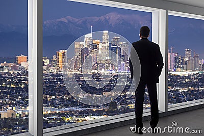 Businessman in an office looking at the view of downtown Los Angeles Stock Photo