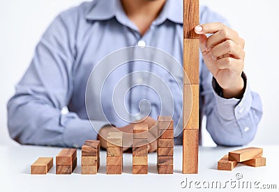 Businessman and outstanding wooden toy block Stock Photo