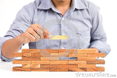 Businessman and outstanding wooden toy block Stock Photo