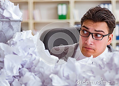 Businessman in paper recycling concept in office Stock Photo