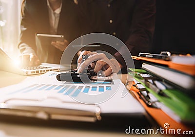 Businessman and partner using calculator and laptop for calculation finance, tax, accounting, statistics. Stock Photo