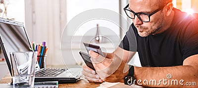 Businessman paying with credit card on smart phone Stock Photo