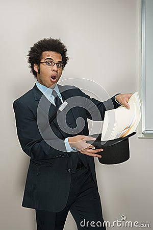 Businessman performing magic tricks Stock Photo