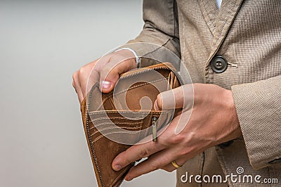 Businessman person holding an empty wallet, no money Stock Photo