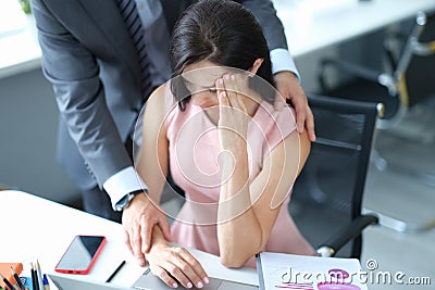 Businessman pestering female colleague in the workplace. Stock Photo
