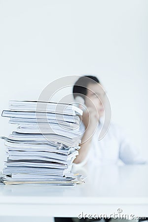 Businessman on the phone with a stack of papers on the desk Stock Photo