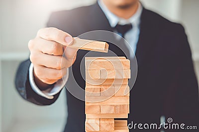 Businessman plan and strategy in business Domino Effect Leadership Management Solution concept Stock Photo