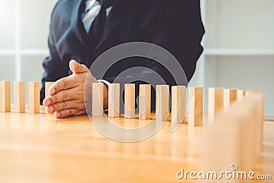 Businessman plan and strategy in business Domino Effect Problem Stock Photo