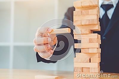 Businessman plan and strategy in business Domino Effect Problem Solving Stock Photo