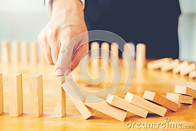 Businessman plan and strategy in business Domino Effect Problem Solving Stock Photo