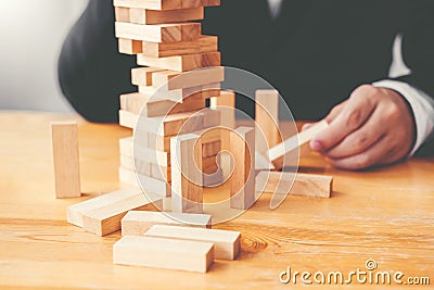 Businessman plan and strategy in business Domino Effect Problem Solving Stock Photo