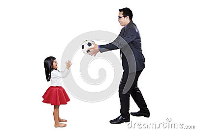 Businessman playing ball with his daughter Stock Photo