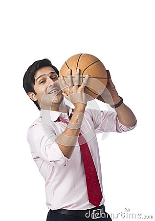 Businessman playing basket ball Stock Photo