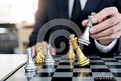 Businessman playing chess figure take a checkmate another king with team, strategy or management win or success concept Stock Photo