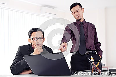 Businessman pointing finger to laptop Stock Photo