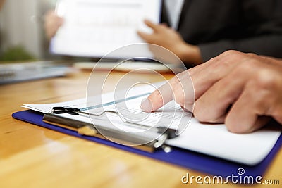 Businessman pointing monthly graph chart in meeting room. Data analyzing to find out the result. Business strategy concept Stock Photo