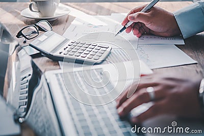 Businessman pointing with pen on business report chart are working on accounts in business analysis with graphs and documentation Stock Photo