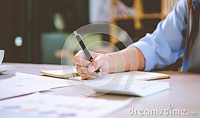 businessman pointing with pen on business report chart are working on accounts in business analysis with graphs and documentation Stock Photo