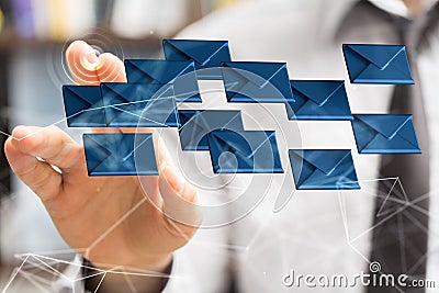 Businessman pointing to a 3D rendered hologram of blue envelope icons in cyberspace Stock Photo