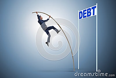 The businessman pole vaulting over debt in business concept Stock Photo