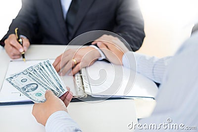 Businessman or politician taking bribe and Shaking Hands With Money in a suit, corruption trade exchange concept Stock Photo
